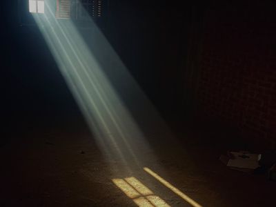 Soft morning light streaming into a quiet room, illuminating dust motes.